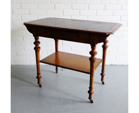 An oak side table, the rectangular top with inset black leather skiver over a single frieze drawer and undertier on turned su