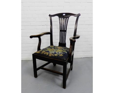 A 19th century mahogany open armchair, the shaped top rail with a pierced splat with scrolling arms and tapestry upholstered 