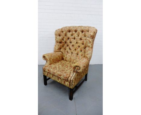 A silk upholstered button-back wing armchair on block supports, 114cm x 84cm 