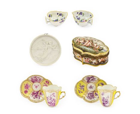 A Pair of Helena Wolfsohn Porcelain Twin-Handled Chocolate Cups and Covers, circa 1900, of lobed oval form, painted in puce m