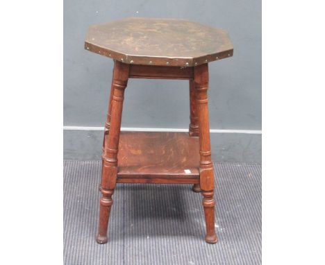 An Edwardian mahogany spindle back rocking armchair and an oak two tier occasional table with octagonal hammered copper top o