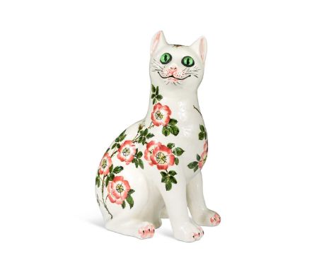 Brian Adams for Wemyss Exon, a model of a seated cat, decorated with floral sprays and inset with green glass eyes, painted m