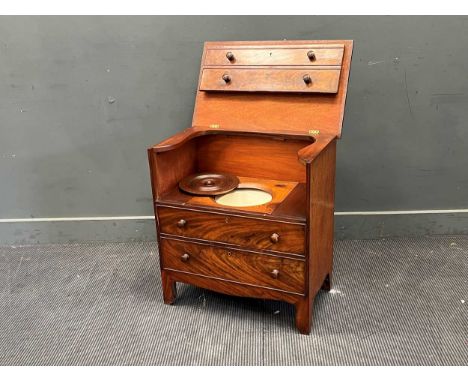 Commode, as a mahogany chest of drawers, with turned wooden handles. The top lifts to the vertical to expose the lidded pot70