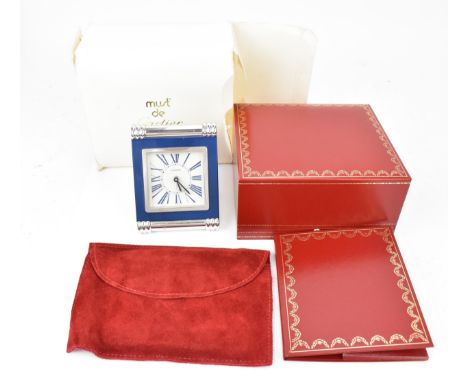 A Cartier travel alarm clock in a rectangular strut frame with turned and ribbed chrome supports, Lapis Lazuli surrounding th