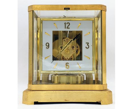 A Jaeger Le Coultre Atmos clock circa 1960s, in a gilt brass case, having a square cream chapter ring with baton and Arabic n