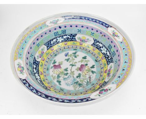 A Chinese Qing dynasty enamelled porcelain basin, 19th century, with polychrome enamel friezes with fruit cartouches, the cen