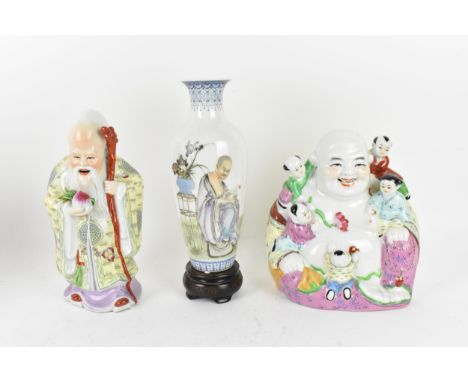 A 20th century Chinese porcelain model of the laughing buddha, with five children around, decorated with polychrome enamels, 