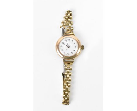 An early 20th century Rolex, manual wind, ladies, 9ct gold wristwatch, having a white dial with Roman numerals, on a gold pla