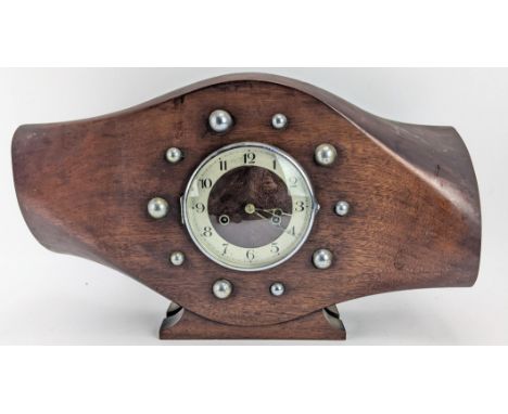 An early/mid 20th century mahogany propeller boss mantle clock, the 6 inch dial having a chrome surround and silvered chapter