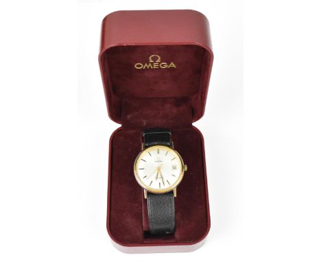 An Omega, manual wind, gents, gold plated wristwatch, having a silvered dial, centre seconds, date aperture at 3, on a black 