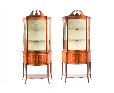 A pair of Edwardian marquetry inlaid mahogany serpentine display pier cabinets, in the manner of Jones of Dublin, each cabine