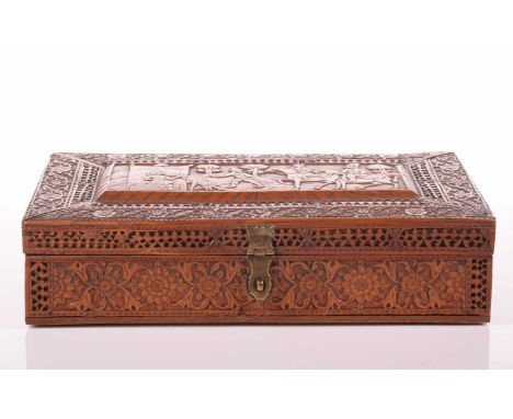 A large finely carved Persian rectangular sandalwood table box, Qajar Dynasty, 19th century, the cover carved with a royal hu