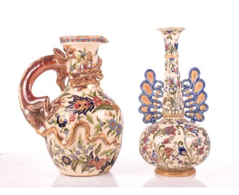 A large Zsolnay Pecs ewer or jug, the handle formed as a dragon, the body florally decorated, 26.5 cm high, together with twi