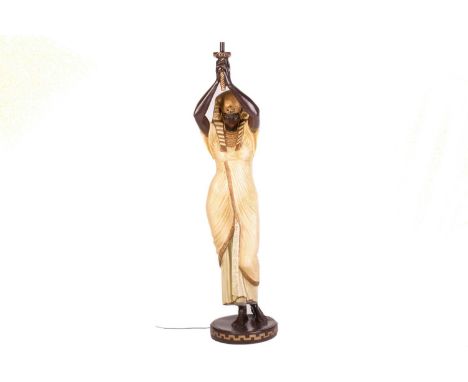 Twentieth-century painted and parcel gilt composition figural floor lamp in the form of a pharaonic torch bearer in the style