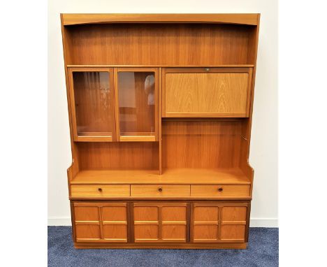 NATHAN TEAK ILLUMINATED SIDE CABINETwith an upper open shelf above a pair of glass cupboard doors and a panelled fall flap wi