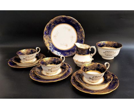 AYNSLEY TEA SETwith a navy blue, gilt and cream ground comprising twelve cups and saucers, twelve side plates, sandwich plate