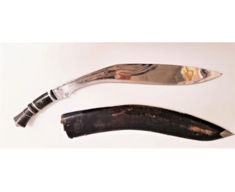 LARGE KUKRI KNIFEwith a curved 60cm etched blade and ebony handle with a lion mask, contained in a leather and wood scabbard 
