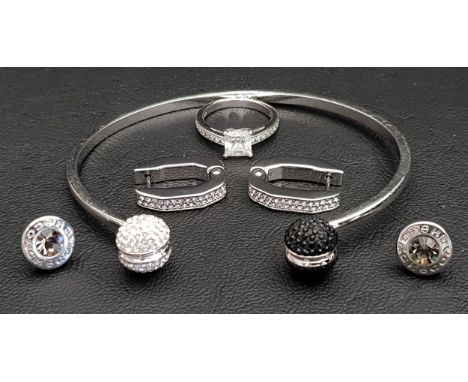 SELECTION OF SWAROVSKI JEWELLERYcomprising a crystal ball finial bangle, a pair of earrings and a ring; together with a pair 