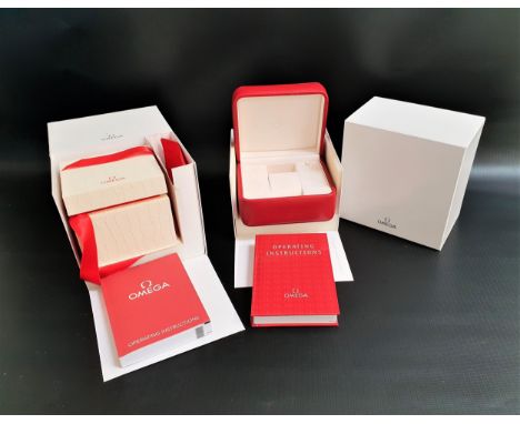 OMEGA RED LEATHER WATCH BOXwith an Omega operating instruction book, an Omega white leather six pocket warranty card holder w