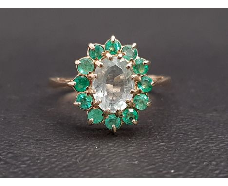 AQUAMARINE AND EMERALD CLUSTER RINGthe central oval cut aquamarine approximately 1ct in twelve emerald surround, on nine cara