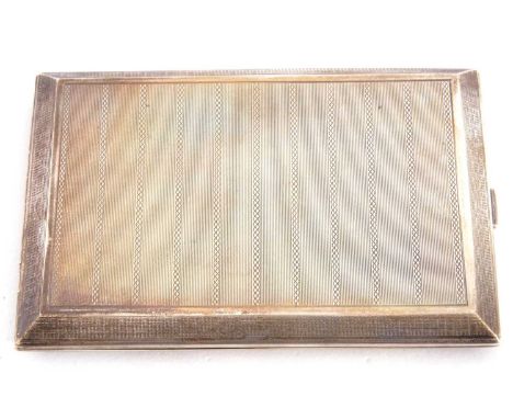 George V silver cigarette case of rectangular form, engine turned decoration, side full length hinge, push clasp opening to a