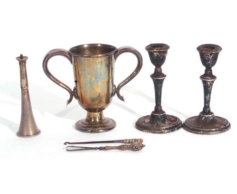 Mixed Lot: old Sheffield plate twin handled trophy cup, 15cm tall, a pair of hallmarked silver candlesticks (loaded), a silve