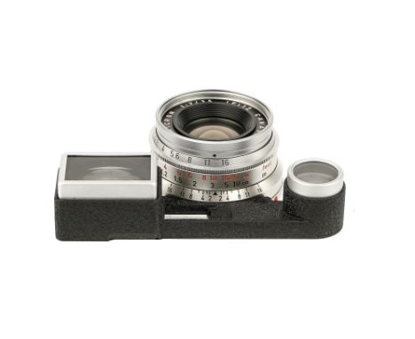 A Leitz Summicron f/2 35mm Lens, 1965, with ocular attachment, chrome, serial no. 2103446, body, VG-E, elements, VG-E, some v