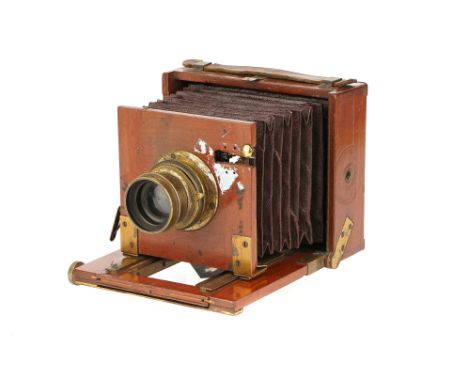 An A. H. Baird Quarter Plate Mahogany Field Camera, 1890-1900, rollerblind shutter behind lens, with unmarked brass lens, bod