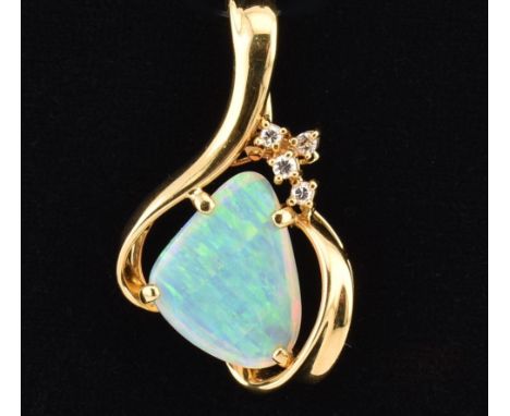 An Australian 18ct /750 gold diamond and opal pendant. The large pendant set with four round brilliant cut diamonds, estimate