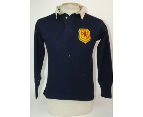 A BLUE SCOTLAND INTERNATIONAL SHIRT with embroidered cloth badge, areas of moth holes and a blue Scotland shirt with button-u