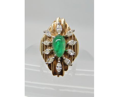 A 14CT GOLD RETRO EMERALD AND DIAMOND FLOWER RING set with marquis diamonds to an estimated approx total of 0.80cts, the pear