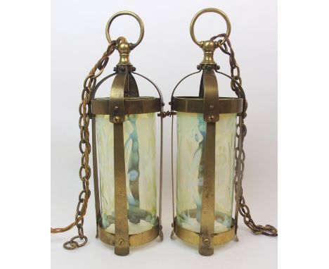 A PAIR OF ARTS AND CRAFTS BRASS CEILING LANTERNS of cylindrical form with vaseline glass shades with flower decoration, 41cm 