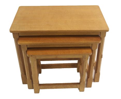 A ROBERT "MOUSEMAN" THOMPSON OAK NEST OF THREE TABLES with octagonal and block legs joined with stretchers, with signature mo