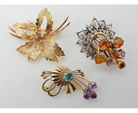 THREE VINTAGE BROOCHES a 9ct gold floral spray brooch, 4.2cm x 3.5cm, a 9ct brooch set with blue zircon and amethyst 4cm x 2.