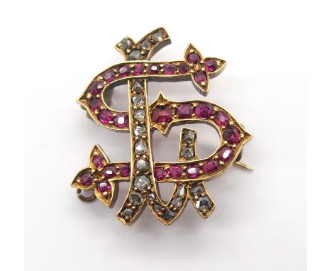 A BRIGHT YELLOW METAL DIAMOND AND RUBY MONOGRAM BROOCH the 'S & L' picked out in rubies and rose cut diamonds. Dimensions 2.3