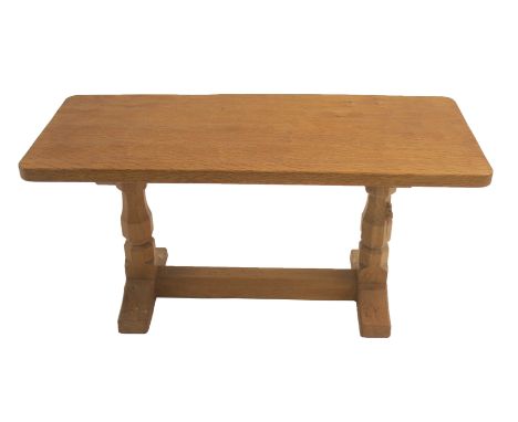 A ROBERT "MOUSEMAN" THOMPSON OAK COFFEE TABLE on two octagonal legs joined by floor stretcher with signature mouse, 46cm high