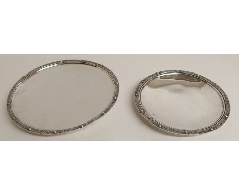 TWO GRADUATED SILVER SHALLOW DISHES by Wakely & Wheeler, London 1941, of circular form with Celtic decorated rims, one 24.5cm
