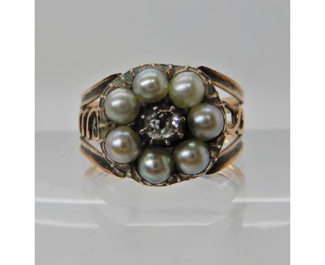 A ROSE COLOURED METAL RING SET WITH AN OLD CUT DIAMOND AND PEARLS in the Georgian style, finger size S, weight 3.9gms Conditi