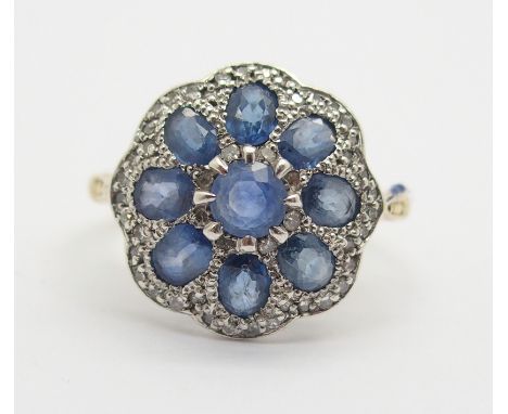 AN 18CT GOLD SAPPHIRE AND DIAMOND FLOWER RING finger size N, weight 3.4gms Condition Report: Linear, platelet and crystal inc