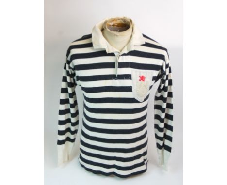 A BLACK AND WHITE QUEEN'S PARK FOOTBALL SHIRT No.7, with button-up collar and embroidered cloth badge, circa late 1930s Condi