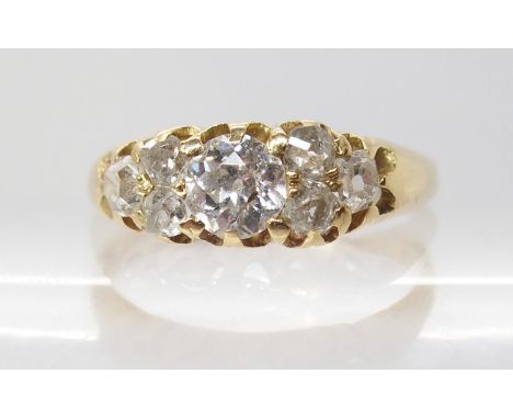 A BRIGHT YELLOW METAL OLD CUT DIAMOND CLUSTER RING the central diamond is estimated approx 0.50cts, with further diamonds tak