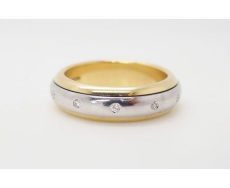 AN 18CT YELLOW AND WHITE GOLD DIAMOND 'SPINNER' RING finger size N1/2, weight 9.5gms Condition Report: Very light wear if any