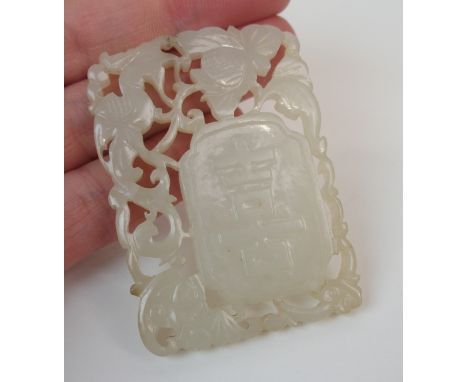 A CHINESE JADE PENDANT carved with shou characters surrounded by a bird and foliage, 5.8cm x 4cm Condition Report: brake and 