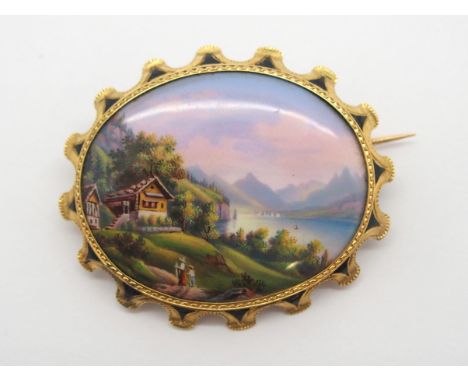 A PAINTED ENAMEL BROOCH DEPICTING THE SWISS RESORT GRUTLI the well painted plaque is 2.8cm x 2.2cm, in bright yellow metal mo