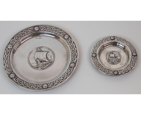A SILVER DISH by Alexander Ritchie, Glasgow 1925, of circular form with Celtic decorated rim, the centre embossed with a Viki