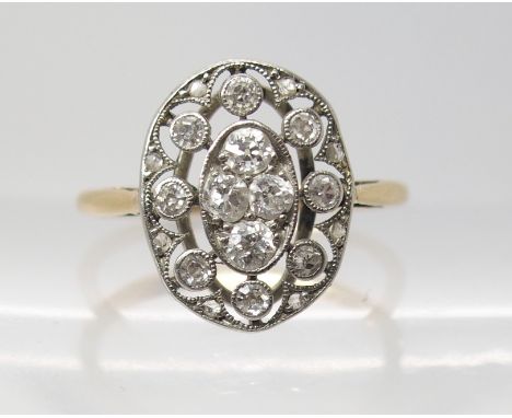 AN 18CT GOLD VINTAGE DIAMOND CLUSTER RING of fine pierced design set with old cut and eight cut diamonds, to an estimated app