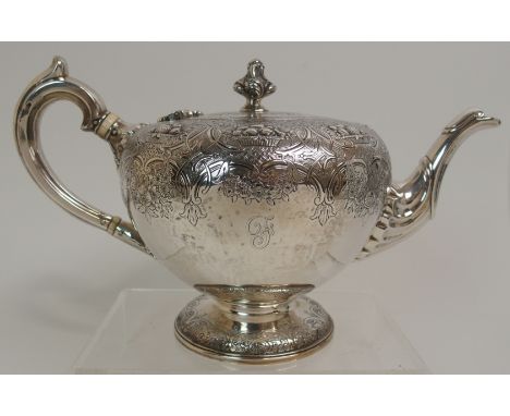 A VICTORIAN SILVER TEAPOT by James McKay, Edinburgh 1857, of globular shape with scrolling handle, the body embossed with bas