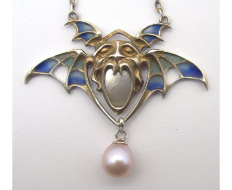 A GERMAN GOTHIC JUGENDSTIL PLIQUE-A-JOUR ENAMELLED WINGED PENDANT with grotesque mask, set with mother of pearl, with pendant