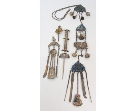A CHINESE WHITE METAL AND ENAMEL CHATELAINE set with foliate panels suspending various attachments and bells, circa 1900, 45c