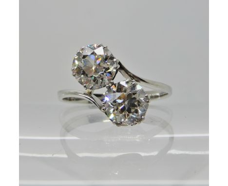 A WHITE METAL TWIN STONE DIAMOND RING the twin diamonds of estimated approx 2.05cts combined, are set on a twist, finger size